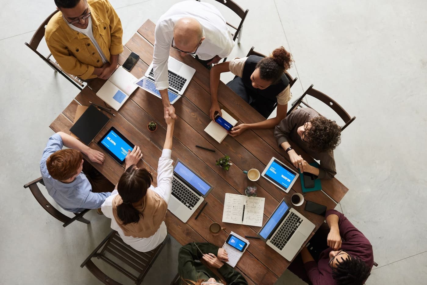 A project team working together around a shared table, seen from above
