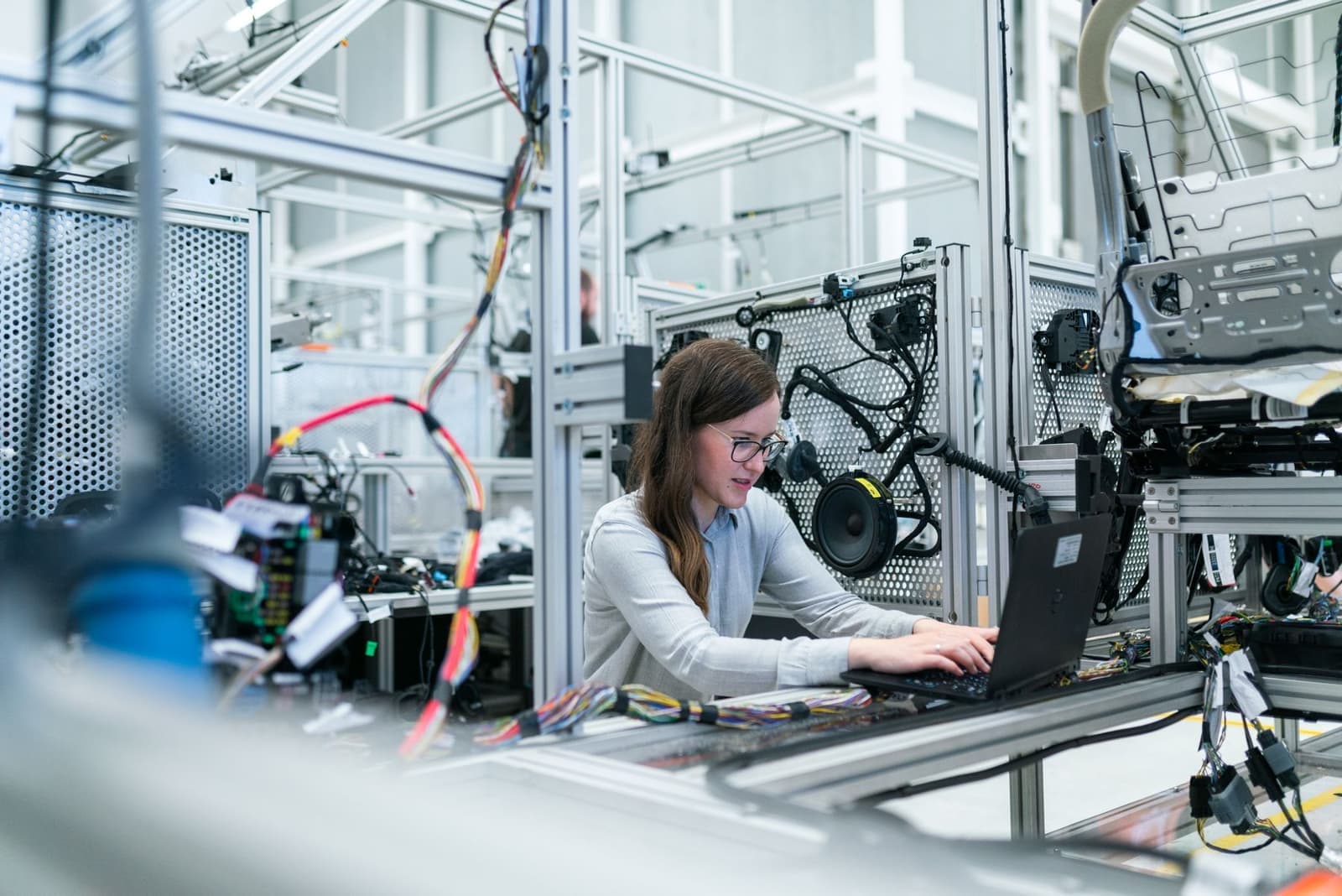 A technician working on equipment in a light industrial workshop
